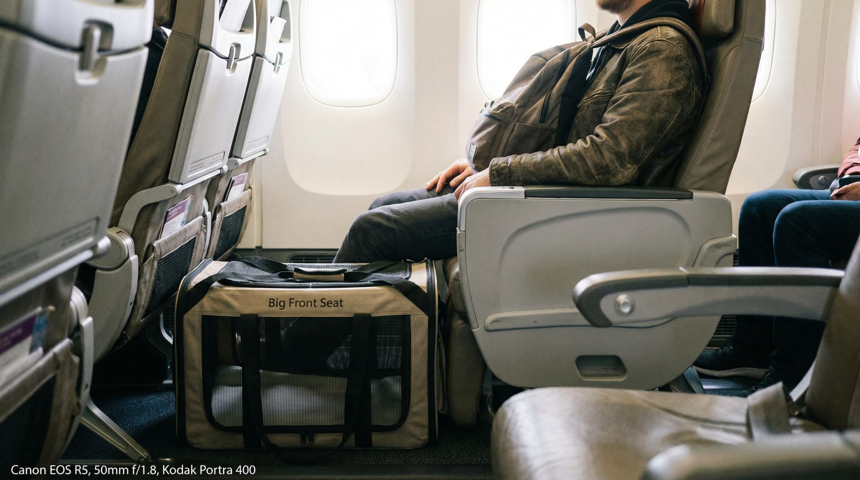Traveler sitting in a Big Front Seat on Spirit Airlines with a pet carrier in the generous footwell space